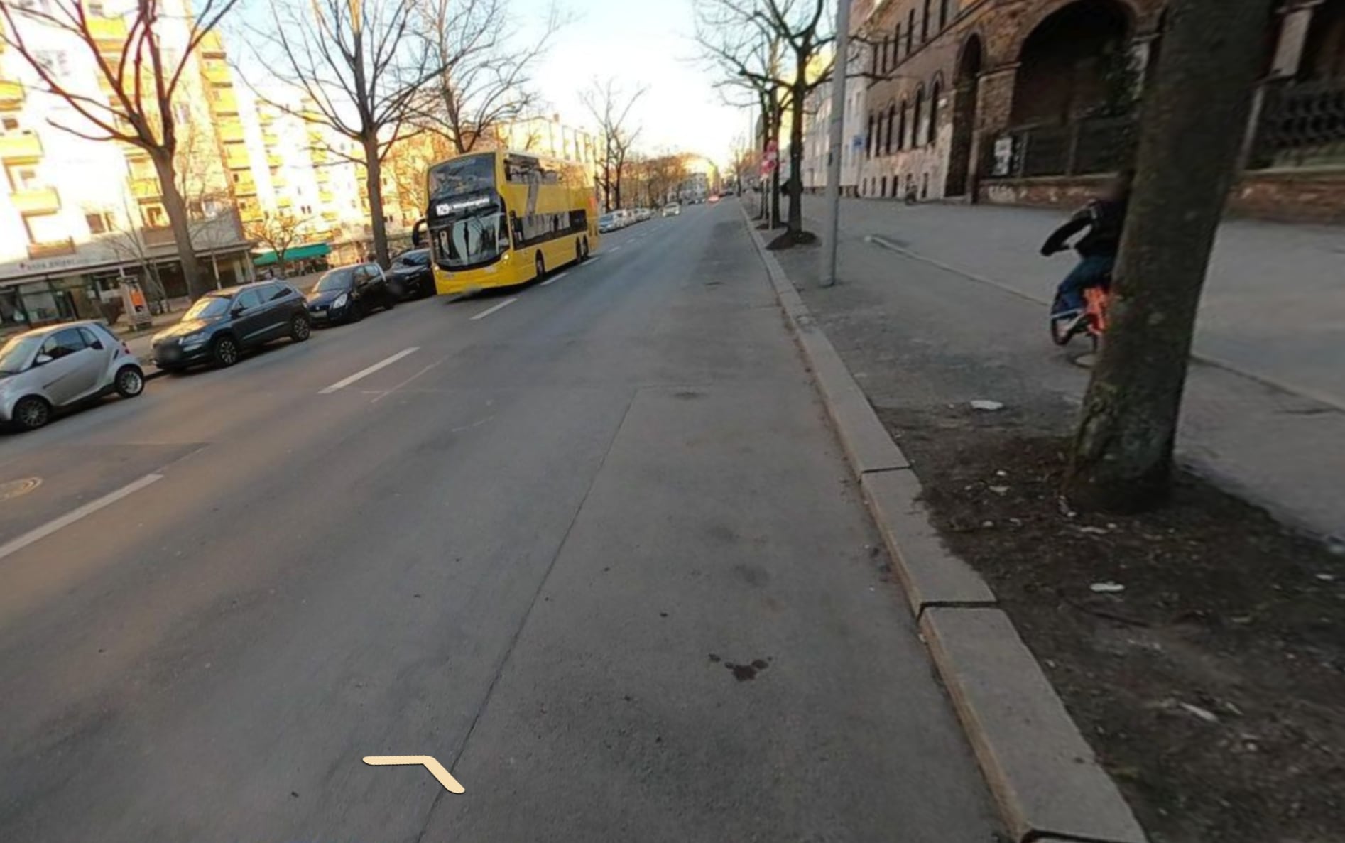Narrow elevated bike path on Oranienstraße in Berlin with gnarly tree roots. Photo by supaplex030 via Mapillary.